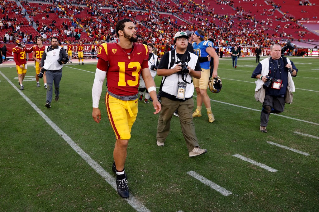 Caleb Williams #13 of USC Trojans walks off after losing to UCLA Bruins on United Airlines Field at Los Angeles Memorial Coliseum.