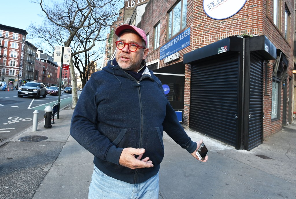 West Village resident James Wilson motions outside the tiny store