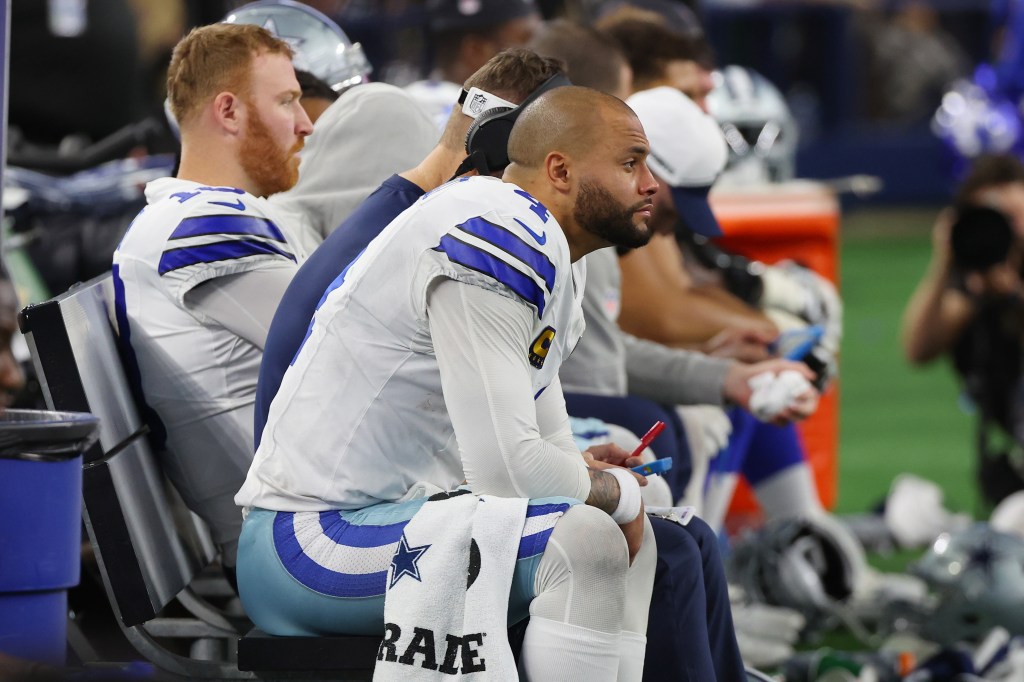 Dak Prescott #4 of the Dallas Cowboys sits on the bench during the fourth quarter of the NFC Wild Card Playoff game against the Green Bay Packers at AT&T Stadium on January 14, 2024