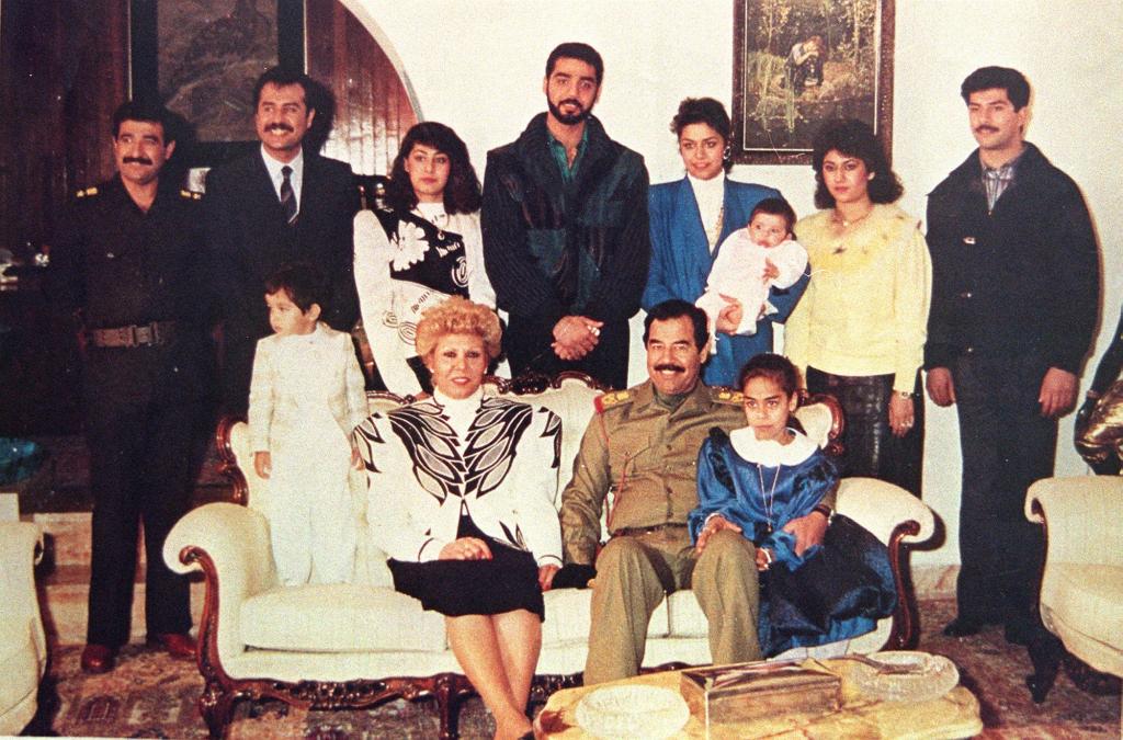 A photo of Saddam Hussein's family in 1990 showing them in a living room.