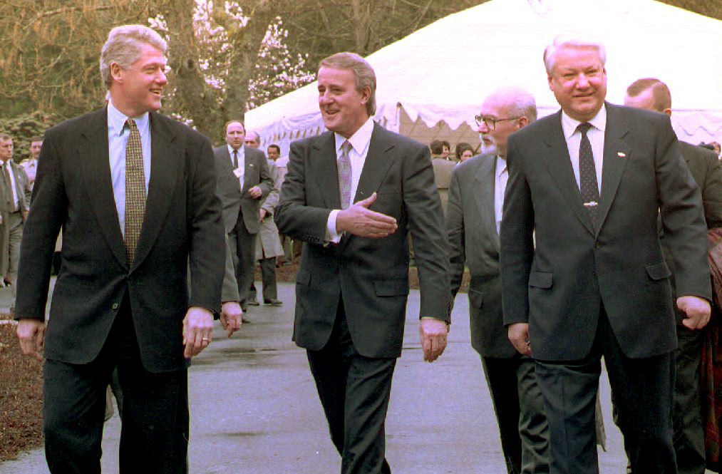 Mulroney and US President Bill Clinton walk together alongside Russian President Boris Yeltsin in Vancouver, BC on April 3, 1993.