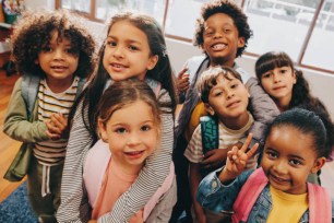 Kids taking a picture together in a elementary school.