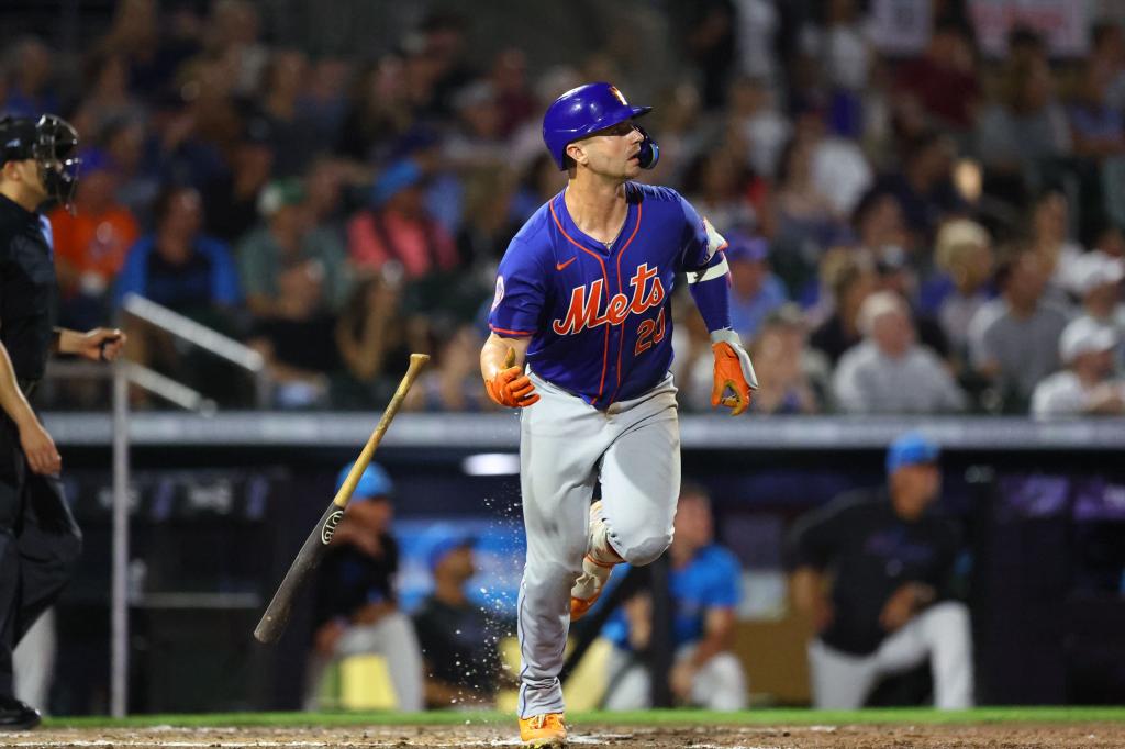 New York Mets player Pete Alonso #20 hitting a home run during a baseball game against the Miami Marlins