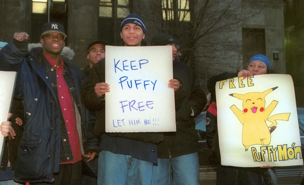 Supporters of Sean 'Puffy' Combs holding signs outside the Manhattan Supreme Court during his 2001 trial on gun possession and bribery charges