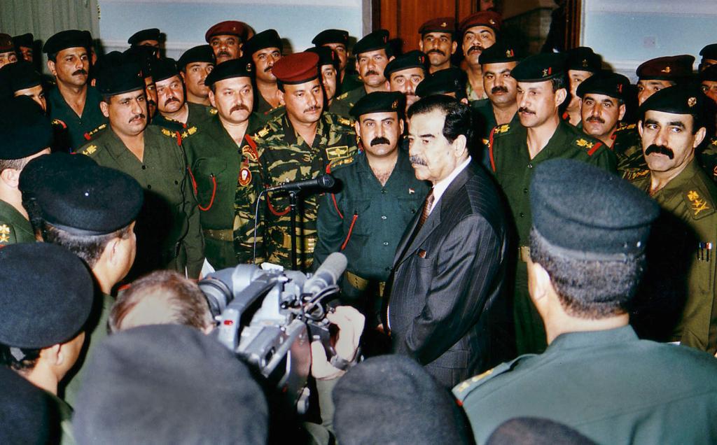 Iraqi President Saddam Hussein talks with elite Republican Guard officers.