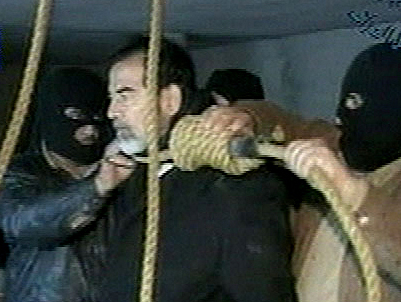 A photo of Saddam Hussein just prior to his hanging as a noose is placed around his neck.
