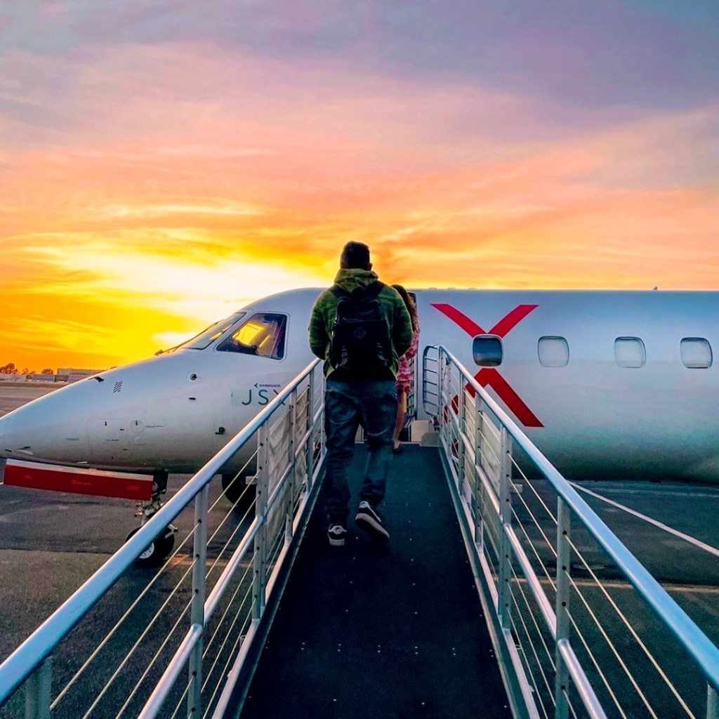 Man walking on a walkway to a plane