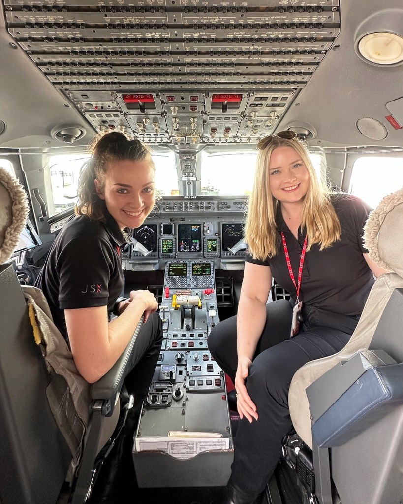 Two women in the cockpit of an airplane