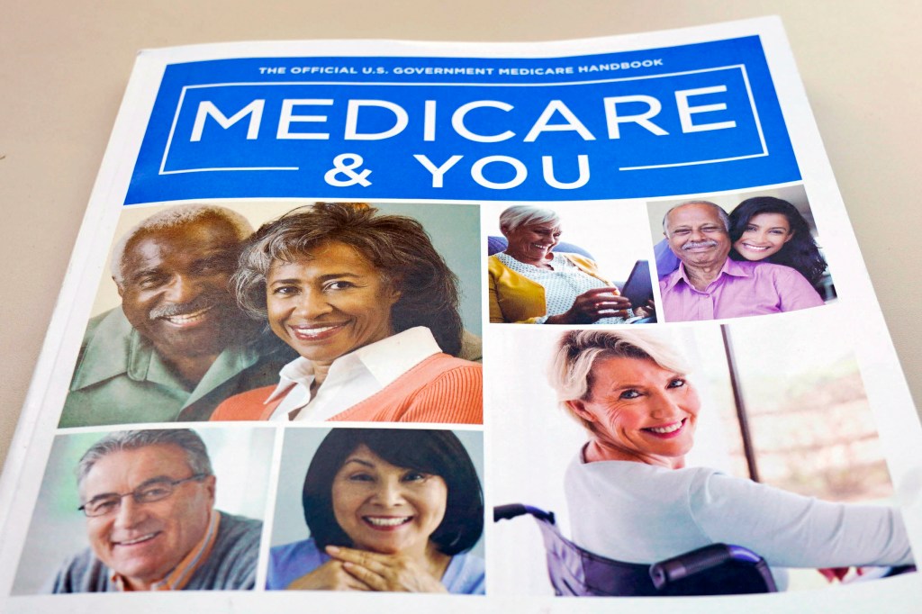 A U.S. Medicare Handbook laying on a table with a blue cover and the title "On-The-Money-NerdWallet-Medicare-Advantage".