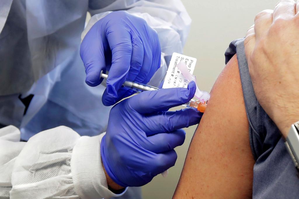 A person receiving vaccine shot in clinical trial for COVID-19.