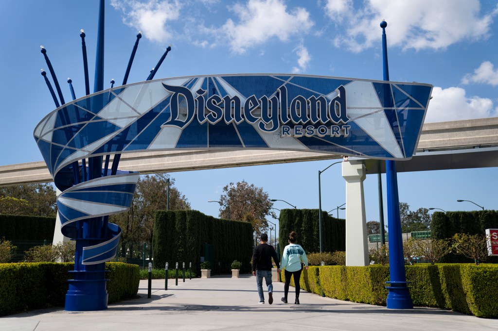 Two people enter Disneyland Resort in Anaheim; Disney seeks to expand the theme park's offerings over the next forty years.