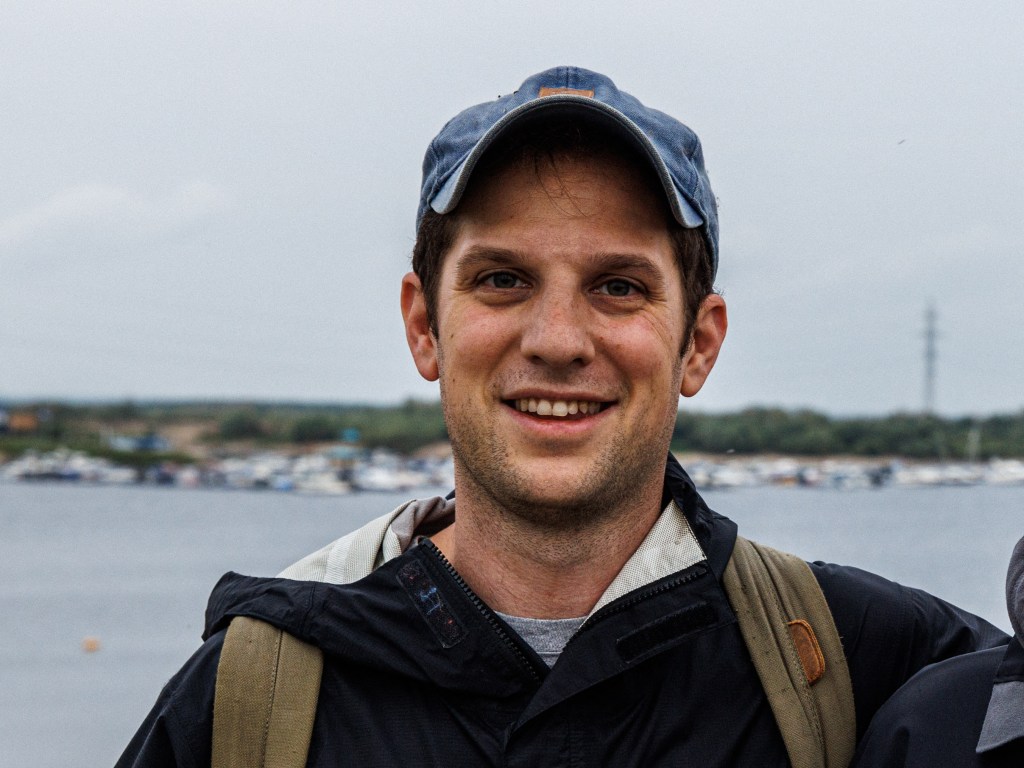 Journalist Evan Gershkovich, wearing a hat and backpack, taken on July 24, 2021