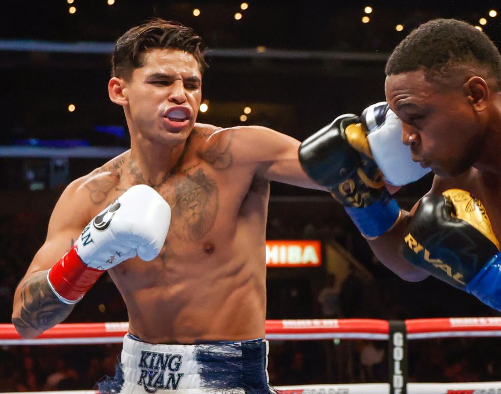 Ryan Garcia, left, hits Javier Fortuna, right, during a lightweight boxing bout July 16, 2022, in Los Angeles.  