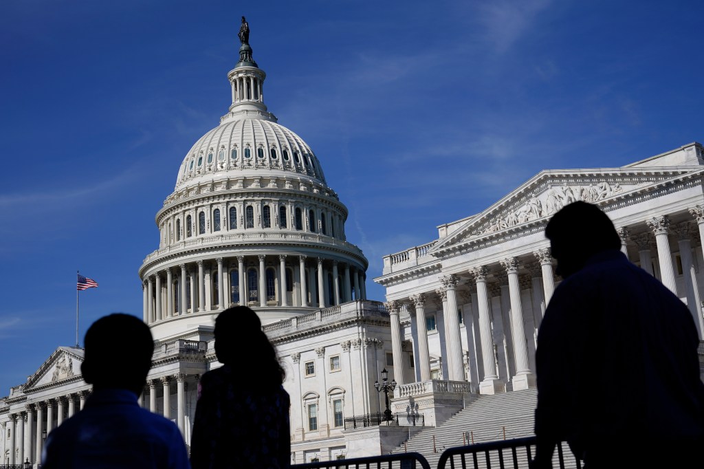 People walk outside the U.S Capitol building in Washington, June 9, 2022. 