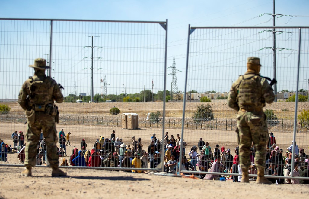 Texas National Guard patrol the southern border in El Paso, Texas as migrants amass along a fence.