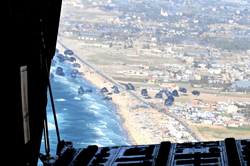 A U.S. Air Force loadmaster releases humanitarian aid pallets of food and water over Gaza, March 2, 2024. The 66 pallets of aid were prepared for airdrop by the U.S. Armyâs 165th Quartermaster Company prior to being loaded aboard three U.S. Air Force C-130J Super Hercules aircraft to execute the mission. (U.S. Air Force photo)