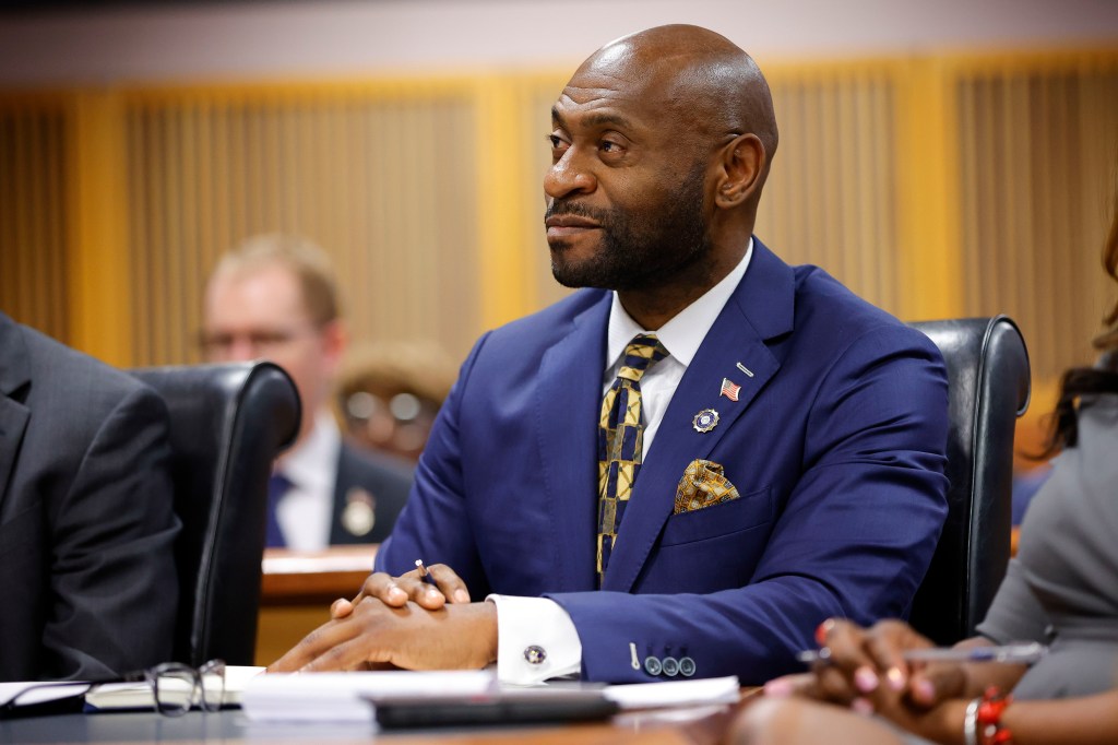 A man in a suit sitting at a table during a hearing on the Georgia election interference case in Atlanta against former President Donald Trump.