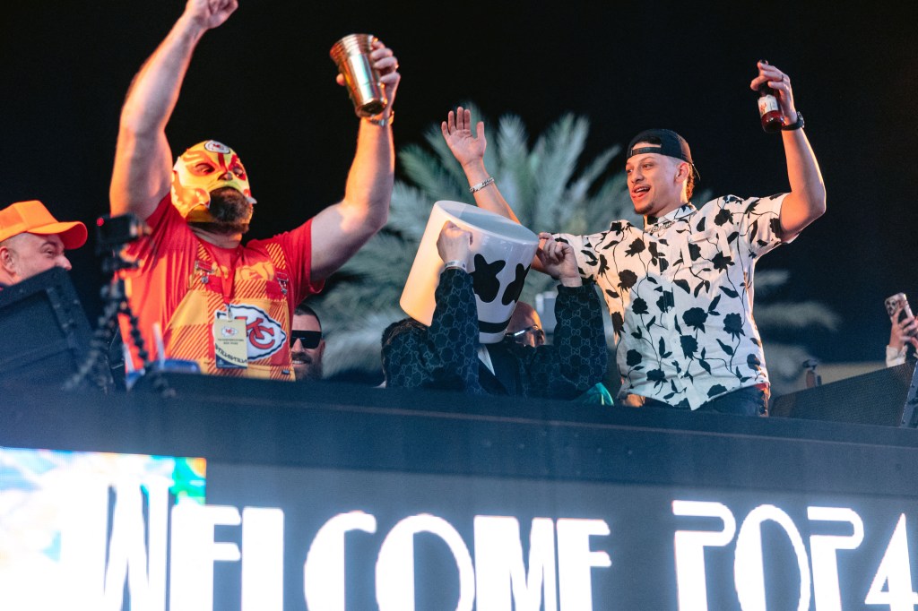 Patrick Mahomes and Jason Kelce. wearing a Lucha Libre wrestling mask, celebrate the Kansas City Chiefs' Super Bowl win at XS Nightclub at Wynn Las Vegas with Travis Kelce and Taylor Swift. 