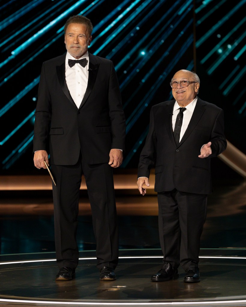 Arnold Schwarzenegger and Danny DeVito onstage at the Oscars. 