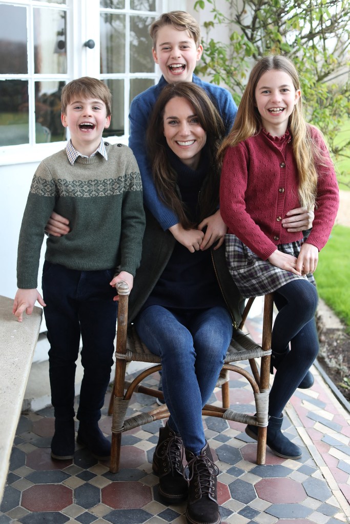 Kate Middleton, seated in a chair outside, with her children Prince Louis, Prince George and Princess Charlotte