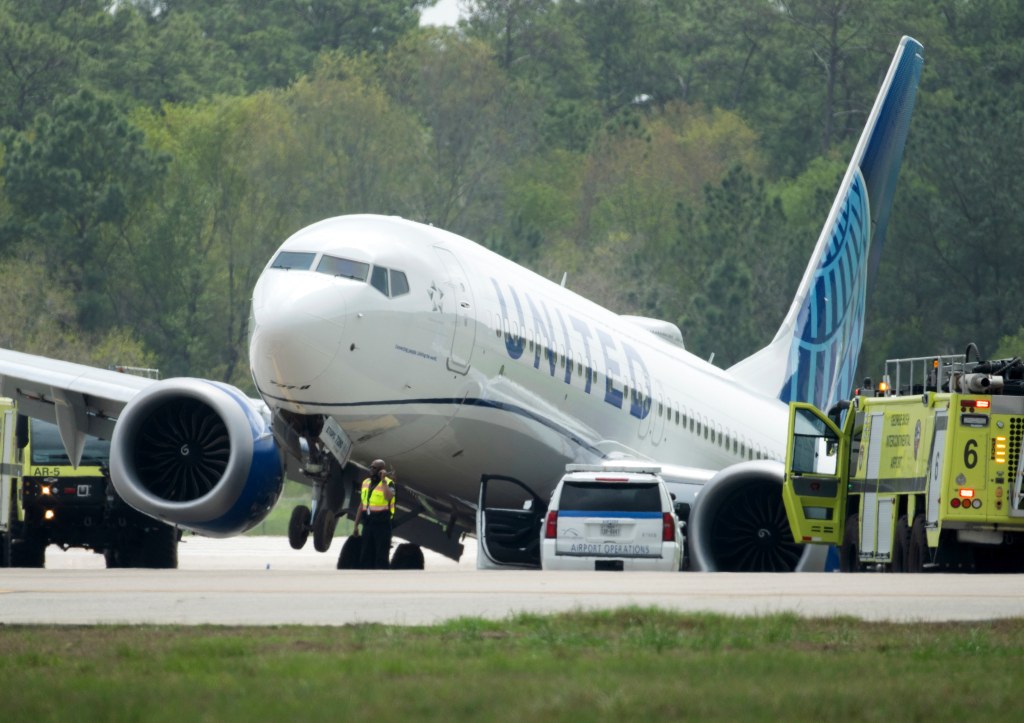 A United Airlines jet sits in a grassy area after leaving the taxiway on Friday.