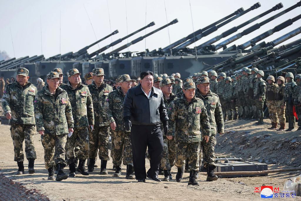 North Korean leader Kim Jong Un, center, supervises artillery firing drills in North Korea Thursday, March 7, 2024.