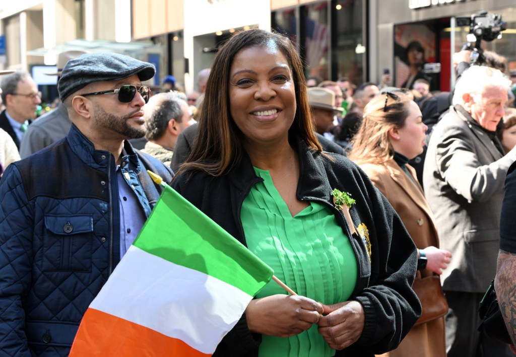NY District Attorney Letitia James holding an Irish flag while marching in the 2024 New York City St. Patrick's Day Parade.