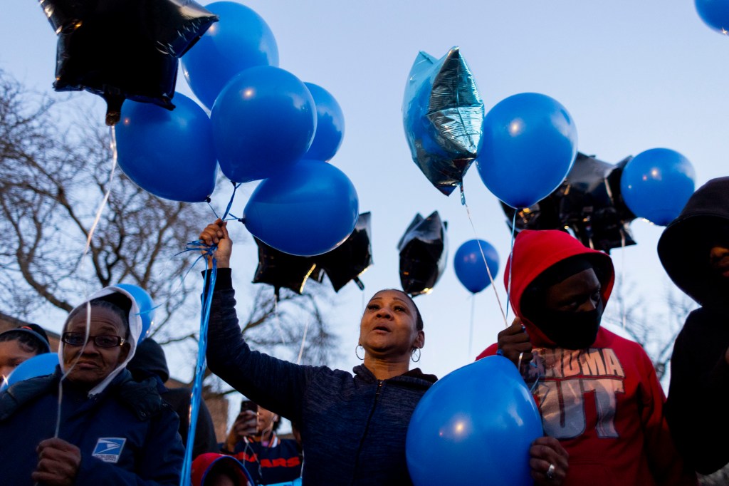 Family members release balloons in honor of Jayden Perkins.