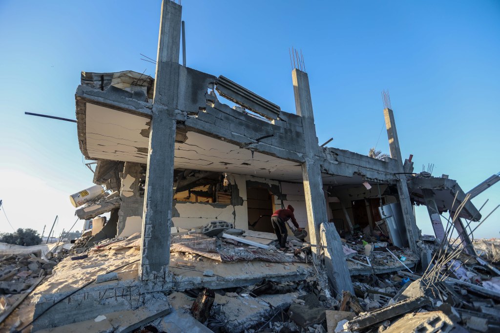 People inspect the damage to their Rafah, Gaza homes following an Israeli air strike on March 15, 2024.