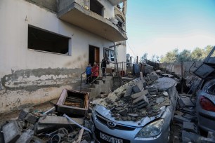 People inspect damage caused to their homes following Israeli air strikes, on February 07, 2024 in Rafah, Gaza.