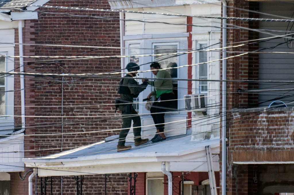 Police remove people from a home in Trenton New Jersey, on March 16, 2024,