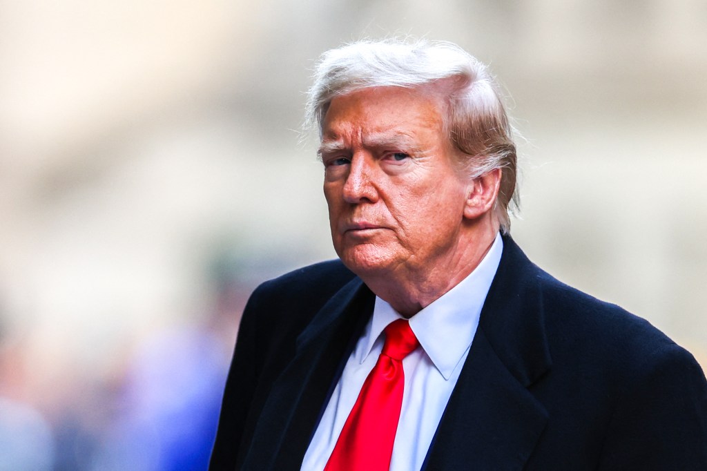 Former US President Donald Trump arrives at 40 Wall Street after his court hearing to determine the date of his trial for allegedly covering up hush money payments linked to extramarital affairs in New York City on March 25, 2024. 