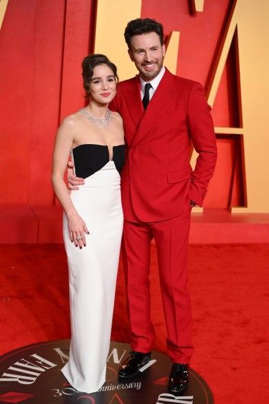 Alba Baptista and Chris Evans posing together at 2024 Vanity Fair Oscar Party hosted by Radhika Jones in Beverly Hills.