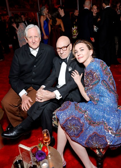 T Bone Burnett, Patrick Stewart, and Sunny Ozell posing for a photo at the 2024 Vanity Fair Oscar Party hosted by Radhika Jones.