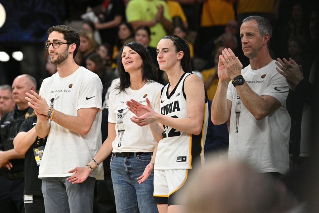 Iowa Hawkeyes guard Caitlin Clark (22) reacts with her family during senior day after the game against the Ohio State Buckeyes. Clark broke the NCAA basketball all-time scoring record during the second quarter at Carver-Hawkeye Arena.