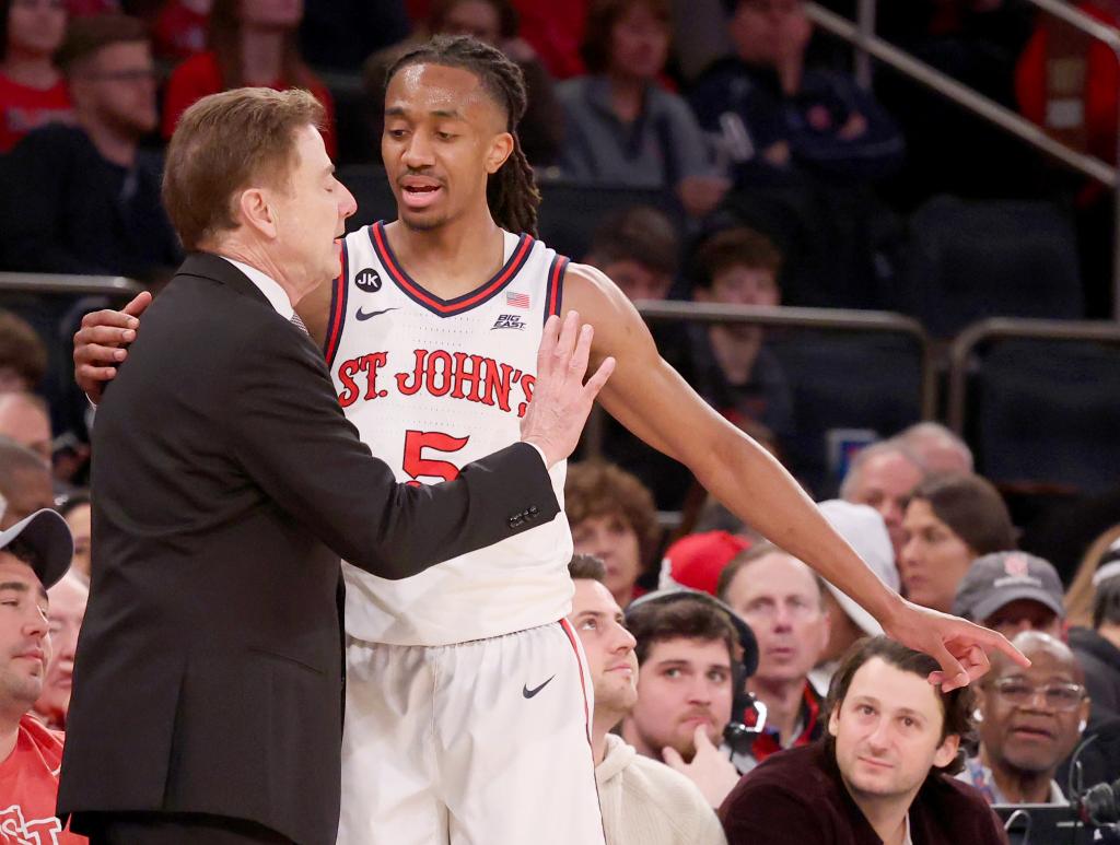 Daniss Jenkins #5 of the St. John's Red Storm speaks with head coach Rick Pitino during the second half when the St. John's Red Storm defeated the Georgetown Hoyas 