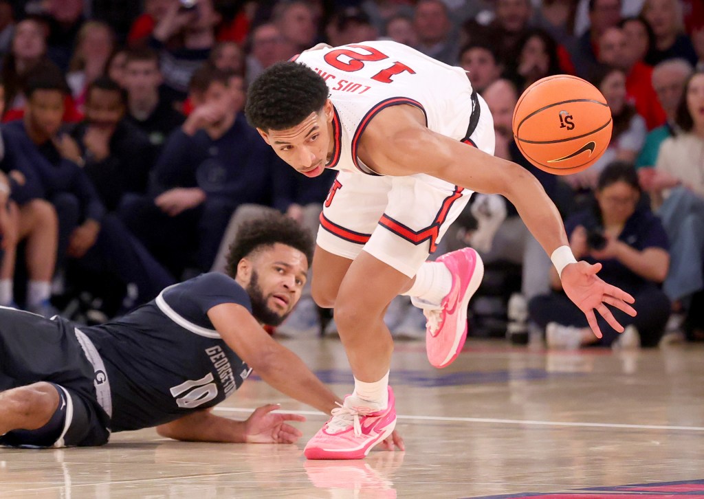 RJ Luis Jr. #12 of the St. John's Red Storm recovers a loose ball from Jayden Epps #10 of the Georgetown Hoyas during the second half when the St. John's Red Storm played the Georgetown Hoyas 