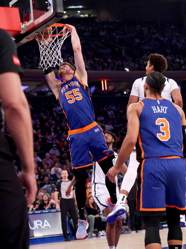 Isaiah Hartenstein #55 of the New York Knicks slams the ball during the first half