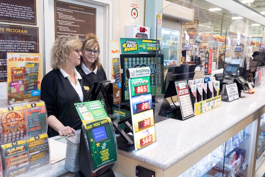 Customer service desk at Shop Rite in Neptune, NJ, where the winning Mega Millions Lottery ticket was sold, with two women standing behind the counter.