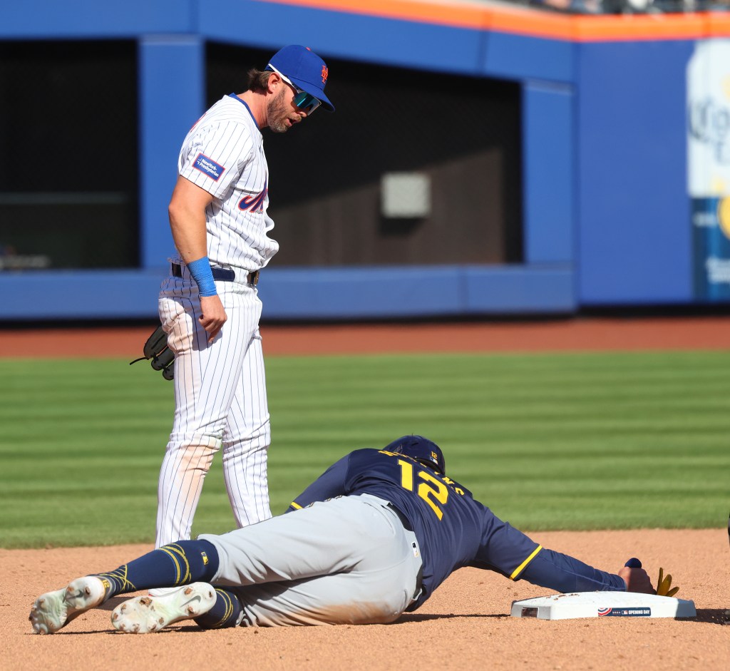 New York Mets second baseman Jeff McNeil (1) believes he is deliberately mowed down trying to turn a double play at second base during the eighth inning by Milwaukee Brewers first baseman Rhys Hoskins (12) causing a much-heated debate