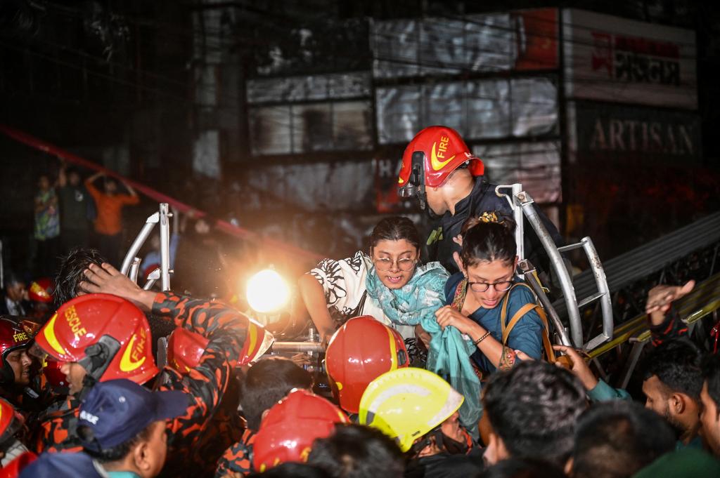 Firefighters use a fire ladder to extract victims during rescue operations following a fire in a commercial building that killed at least 43 people, in Dhaka, on Feb. 29, 2024.