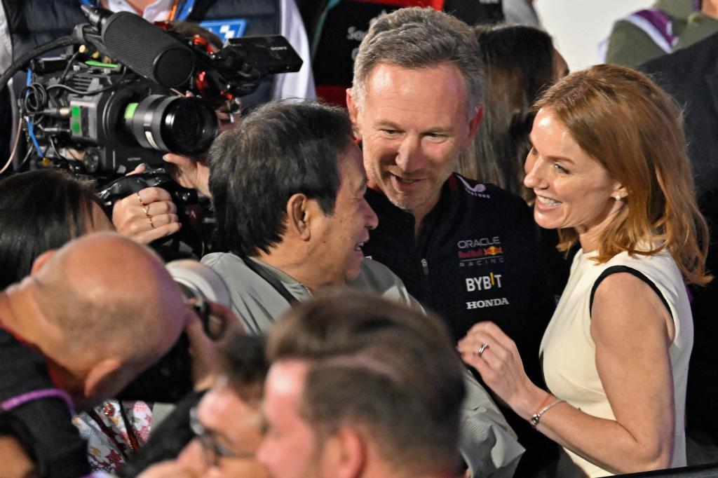 Red Bull Racing team principal Christian Horner (2R) along with his wife British singer Geri Halliwell (R) and Thai businessman Chalerm Yoovidhya (C) attend the podium ceremony of the Bahrain Formula One Grand Prix at the Bahrain International Circuit in Sakhir on March 2, 2024.