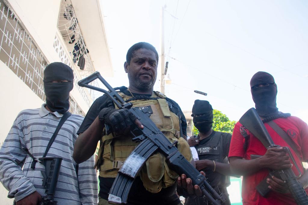 Jimmy "Barbecue" Cherizier (center) with gang members in Port-Au-Prince on March 5, 2024.