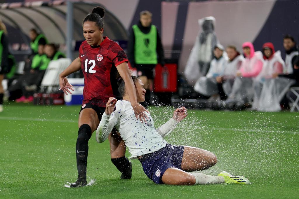 Jade Rose #12 of Canada and Trinity Rodman #22 of the United States collide while chasing after the ball in the first half during the 2024 Concacaf W Gold Cup semifinals at Snapdragon Stadium.