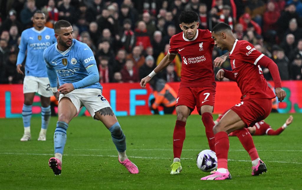 Liverpool's Colombian midfielder #07 Luis Diaz (C) and Liverpool's Dutch striker #18 Cody Gakpo (R) appear to get in each others way during the English Premier League football match between Liverpool and Manchester City at Anfield in Liverpool, north west England on March 10, 2024. 