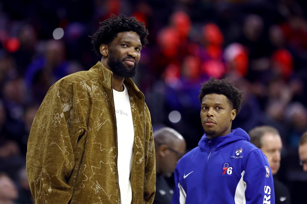 Joel Embiid #21 and Kyle Lowry #7 of the Philadelphia 76ers look on during the fourth quarter at the Wells Fargo Center on March 08, 2024 in Philadelphia, Pennsylvania