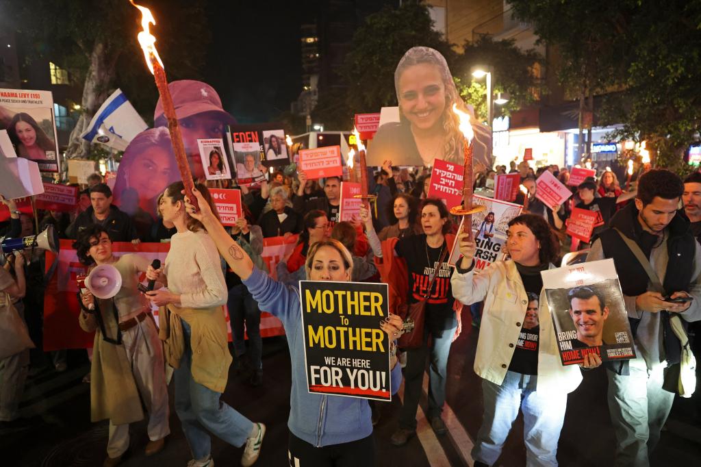 Demonstrators hold placards during a protest calling for the release of Israeli hostages held in Gaza in Tel Aviv on March 14, 2024.