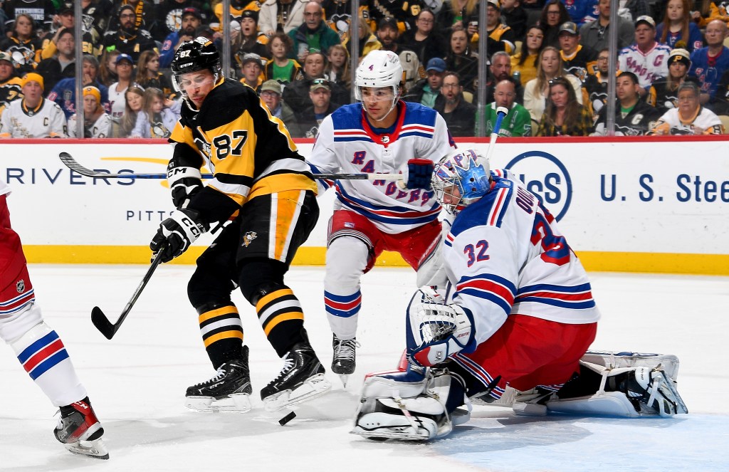 Jonathan Quick #32 of the New York Rangers protects the net against Sidney Crosby #87 of the Pittsburgh Penguins at PPG PAINTS Arena on March 16, 2024 in Pittsburgh, Pennsylvania.