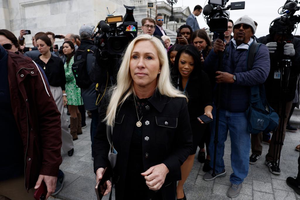 Rep. Marjorie Taylor Greene (R-GA) is followed by reporters after speaking outside the capital building before the vote on March 22.