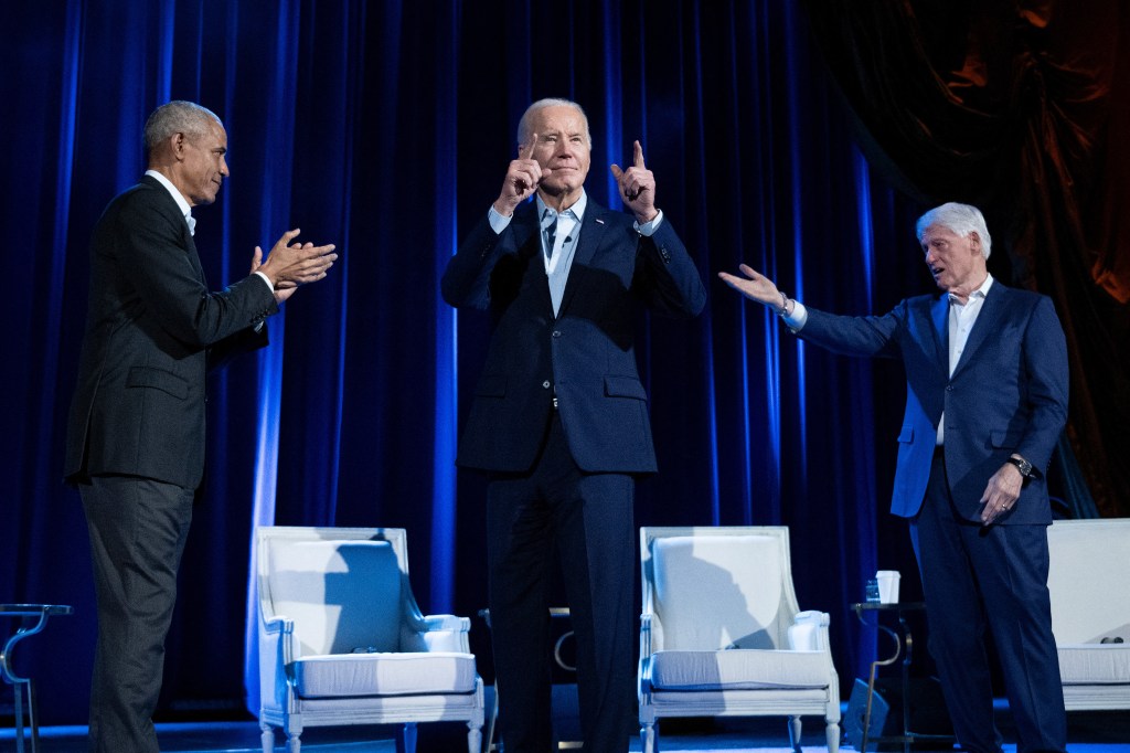 Former Presidents Barack Obama and Bill Clinton cheering for President Joe Biden on stage at a campaign fundraising event at Radio City Music Hall, New York City.